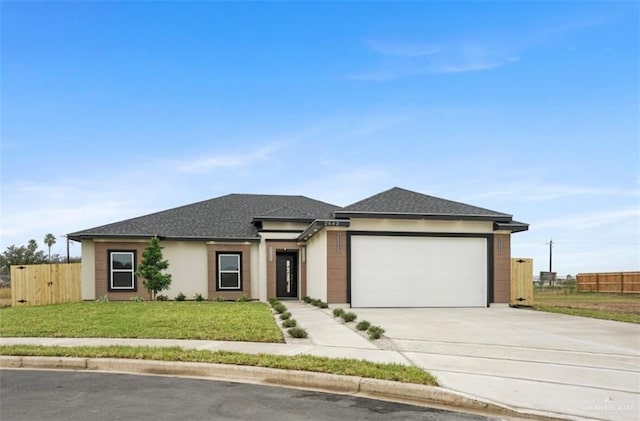 view of front of home featuring a front yard and a garage