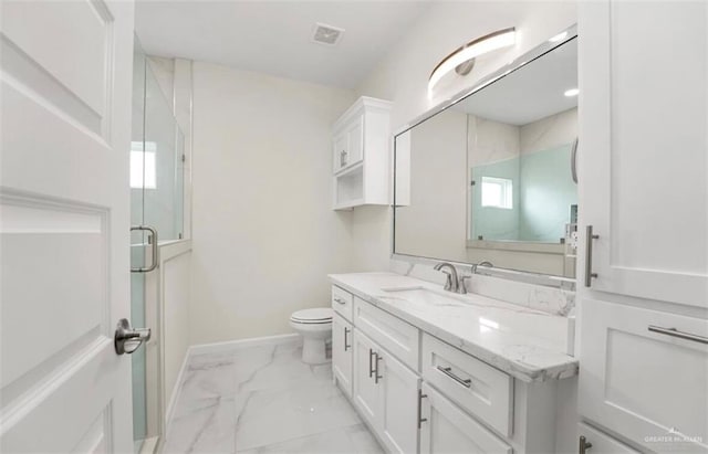 bathroom with vanity, toilet, and walk in shower