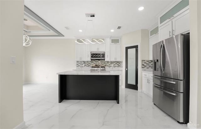 kitchen with sink, backsplash, decorative light fixtures, white cabinets, and appliances with stainless steel finishes