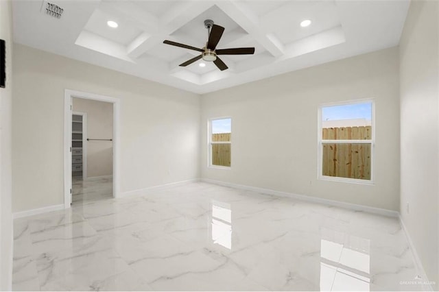 empty room featuring beam ceiling, a wealth of natural light, ceiling fan, and coffered ceiling