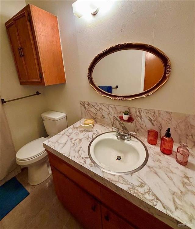 half bathroom featuring toilet and vanity