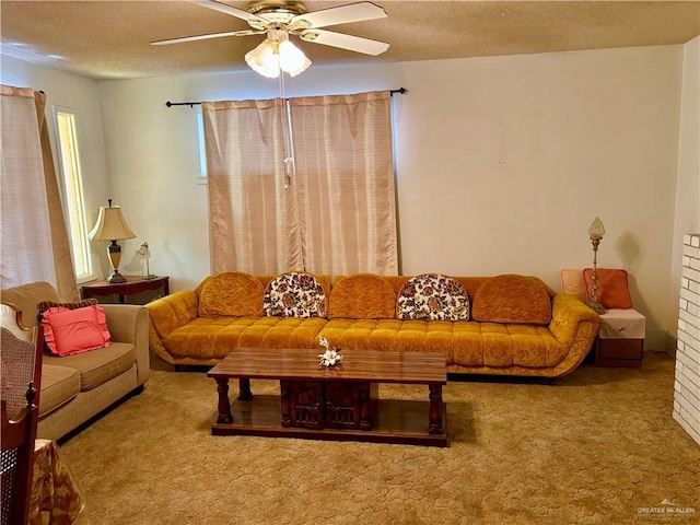 living room featuring a textured ceiling, ceiling fan, and carpet flooring