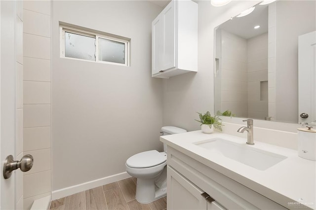 3513 E Adams Ave, Alton, TX 78573 - full bath featuring vanity, toilet, wood finished floors, and baseboards