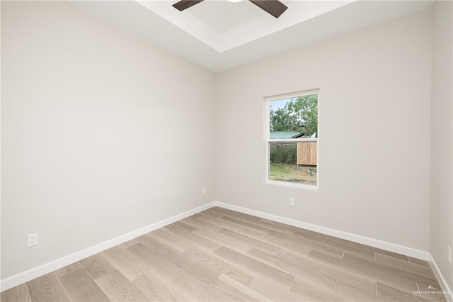 3513 E Adams Ave, Alton, TX 78573 - empty room featuring light wood-style floors, a raised ceiling, a ceiling fan, and baseboards
