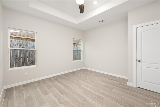 3513 E Adams Ave, Alton, TX 78573 - empty room with light wood finished floors, baseboards, and a raised ceiling