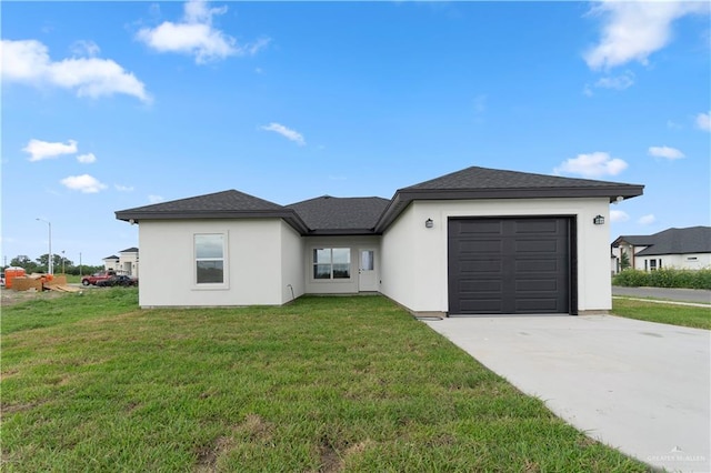 900 E 38th St, San Juan, TX 78589 - view of front facade with concrete driveway, an attached garage, stucco siding, and a front lawn