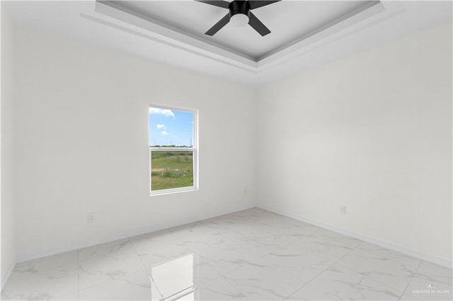 900 E 38th St, San Juan, TX 78589 - empty room featuring baseboards, marble finish floor, and a tray ceiling