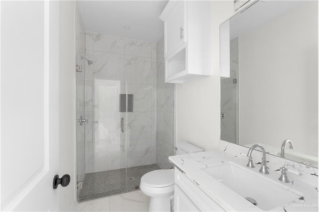 900 E 38th St, San Juan, TX 78589 - bathroom featuring vanity, marble finish floor, a marble finish shower, and toilet