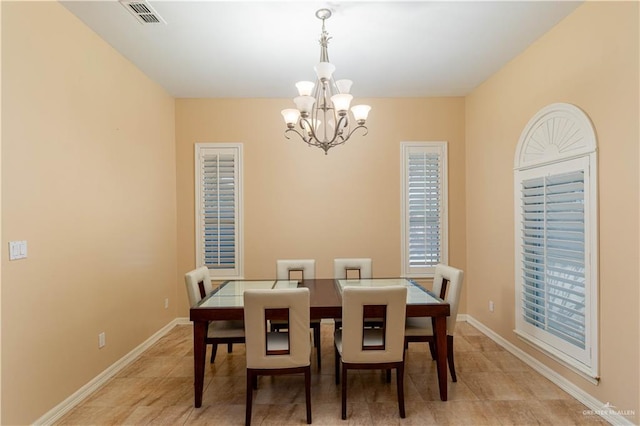 tiled dining area with a notable chandelier