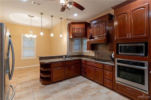 kitchen with kitchen peninsula, decorative backsplash, stainless steel appliances, sink, and decorative light fixtures