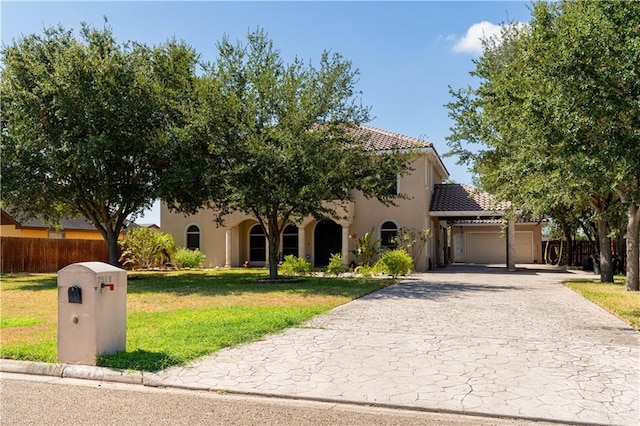 mediterranean / spanish home with a front yard and a garage