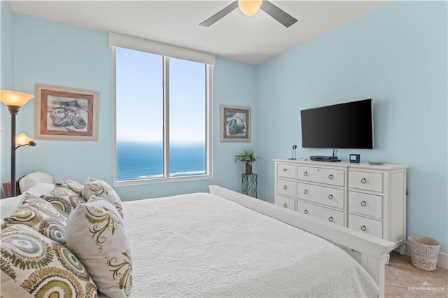 bedroom with a ceiling fan, light tile patterned floors, and multiple windows