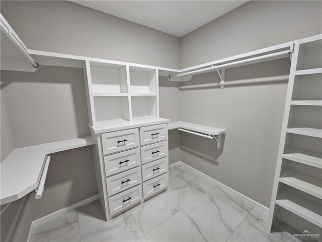 spacious closet with marble finish floor