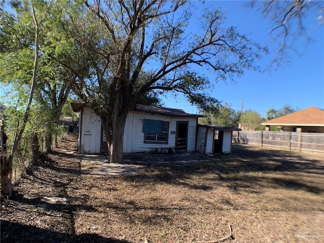 view of front of home with a shed