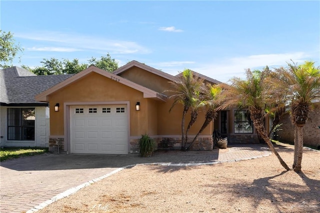 2729 Ashley Ct, Pharr, TX 78577 - ranch-style home with a garage, stucco siding, stone siding, and decorative driveway