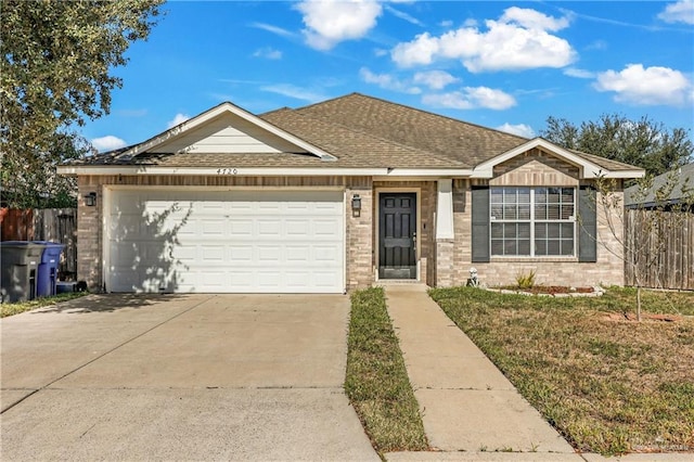 view of front of house with a garage and a front lawn