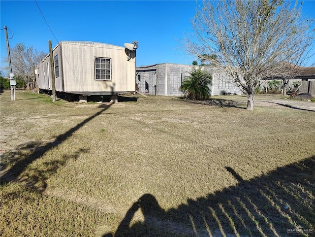 view of side of property with a lawn