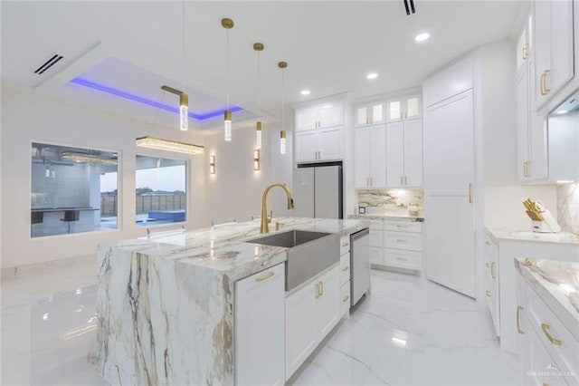 kitchen with pendant lighting, refrigerator, white cabinetry, dishwasher, and a spacious island