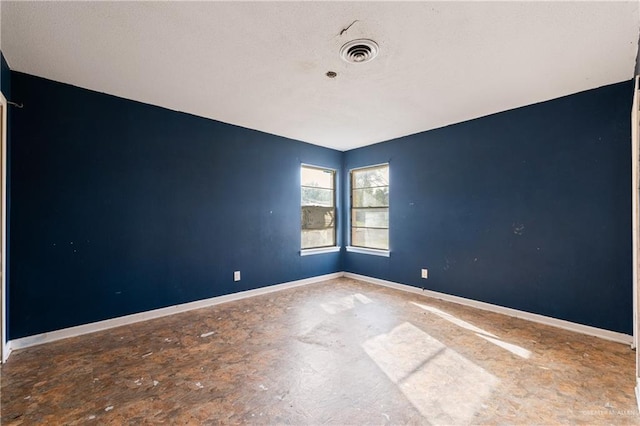 spare room with visible vents and baseboards