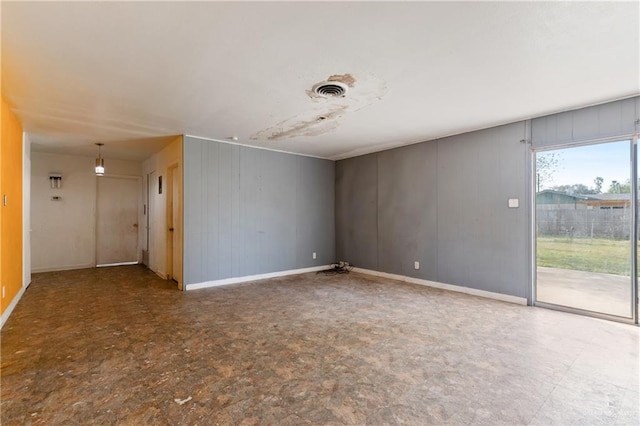 empty room featuring visible vents, baseboards, and tile patterned floors