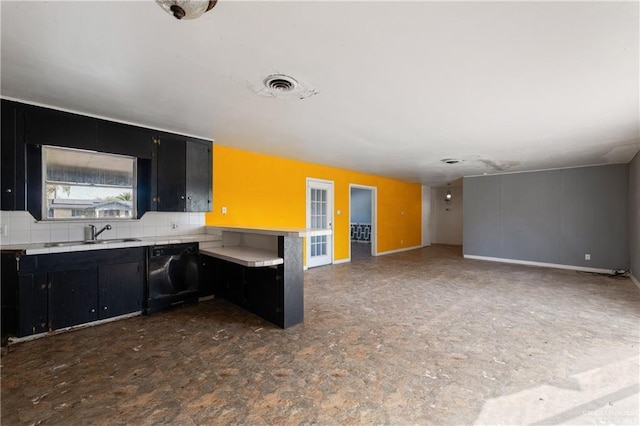 kitchen with light countertops, visible vents, a sink, dark cabinets, and dishwashing machine