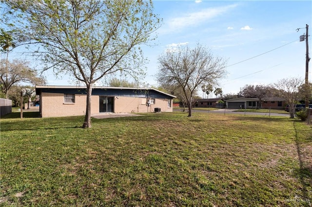 view of yard featuring fence and a patio