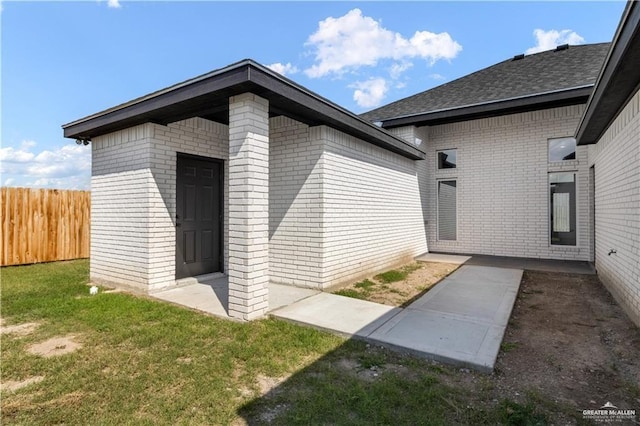537 Kiwi St, Edinburg, TX 78541 - doorway to property featuring brick siding and roof with shingles