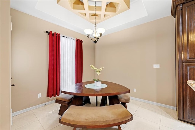 tiled dining room featuring an inviting chandelier and coffered ceiling