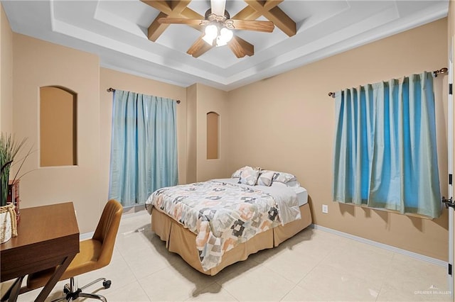 bedroom featuring light tile patterned floors, ceiling fan, and a tray ceiling