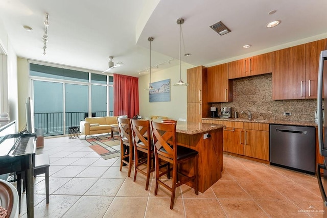 kitchen with pendant lighting, dishwasher, a center island, backsplash, and rail lighting