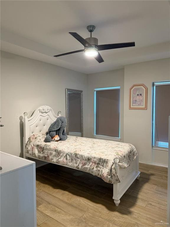 bedroom with ceiling fan and light hardwood / wood-style flooring