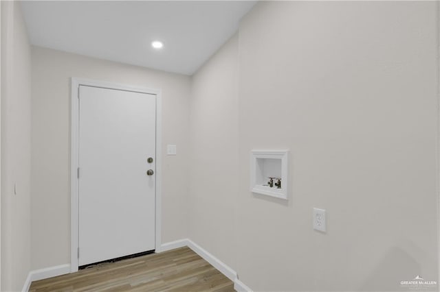 laundry area with washer hookup and light hardwood / wood-style floors