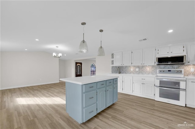 kitchen with white cabinetry, backsplash, decorative light fixtures, and range with two ovens