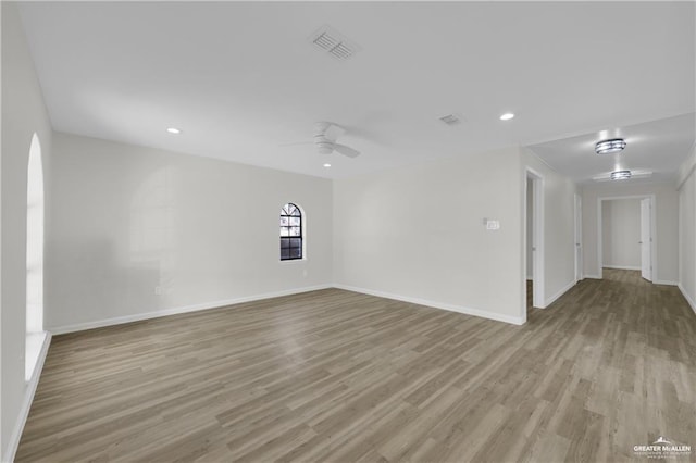 spare room featuring ceiling fan and light hardwood / wood-style flooring