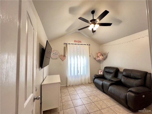 living room with ceiling fan, light tile patterned floors, and vaulted ceiling