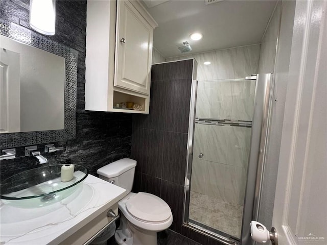 bathroom with walk in shower, tasteful backsplash, toilet, vanity, and tile walls