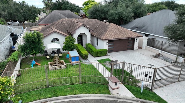 view of front of property featuring a garage and a front lawn