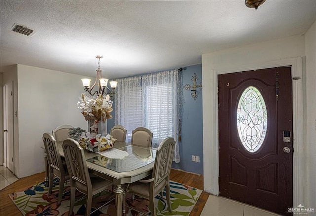 3300 N 20th St, Mcallen, TX 78501 - dining area with plenty of natural light, a chandelier, wood finished floors, and a textured ceiling