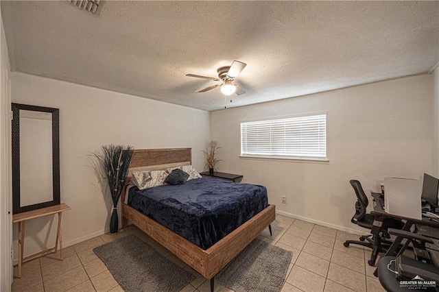 3300 N 20th St, Mcallen, TX 78501 - bedroom featuring light tile patterned floors, a textured ceiling, a desk, ceiling fan, and baseboards