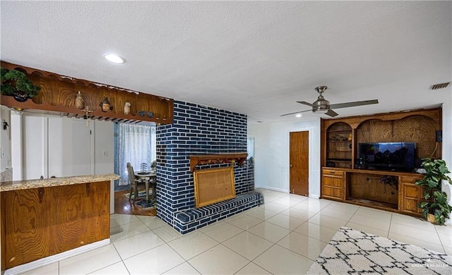 3300 N 20th St, Mcallen, TX 78501 - living room with a fireplace, a textured ceiling, a ceiling fan, recessed lighting, and light tile patterned flooring