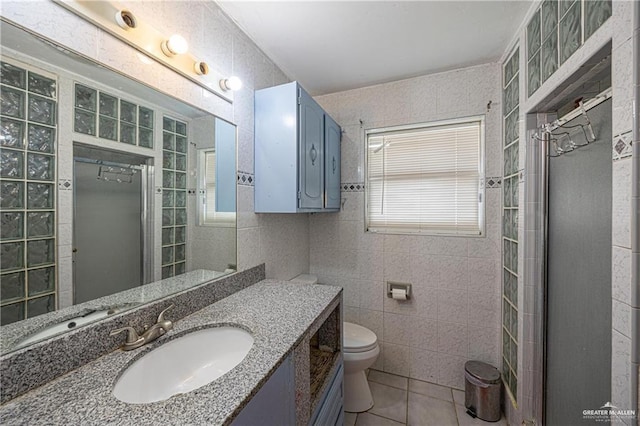3300 N 20th St, Mcallen, TX 78501 - full bath featuring tile patterned floors, tile walls, toilet, vanity, and a shower