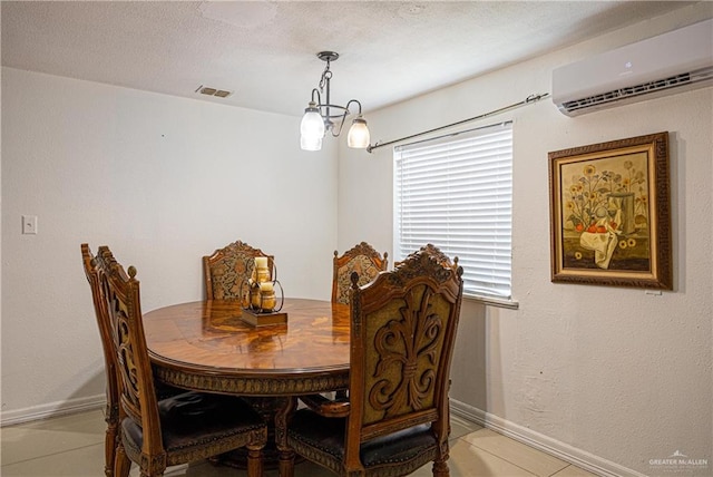 dining space featuring a chandelier, light tile patterned floors, and an AC wall unit