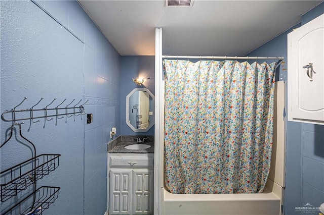 bathroom with vanity and shower / bath combo