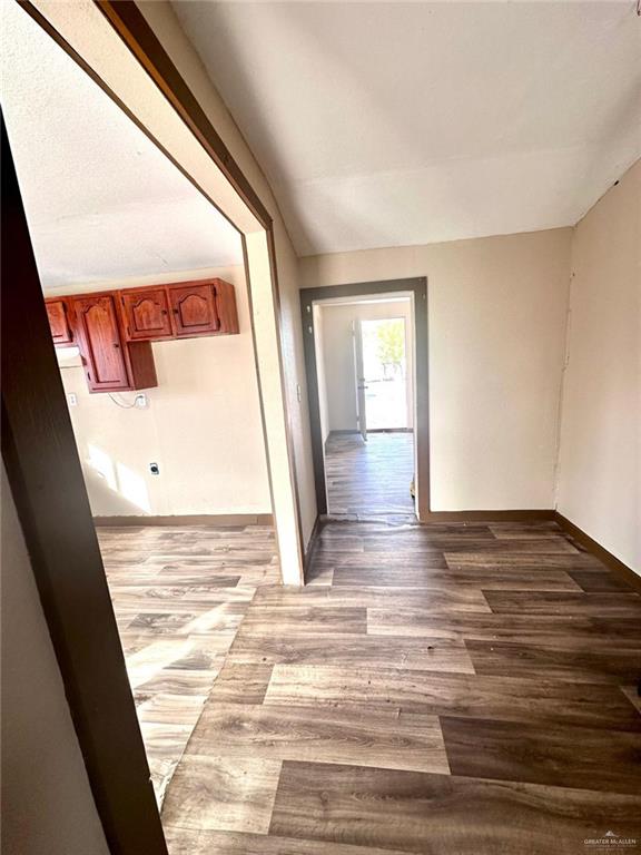 corridor with wood-type flooring