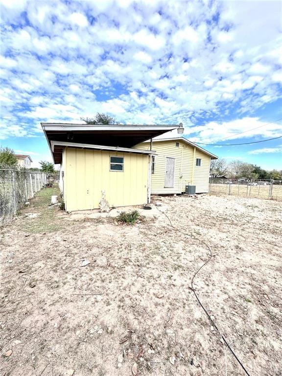 back of property with central AC