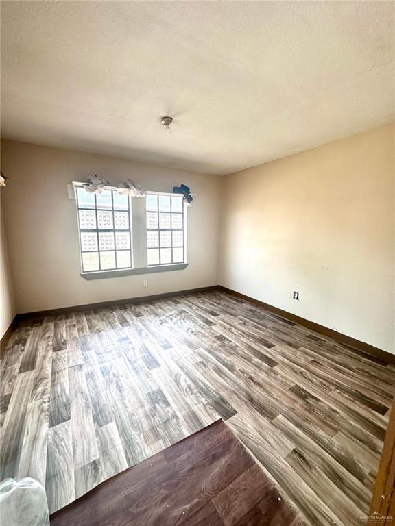 empty room featuring hardwood / wood-style flooring