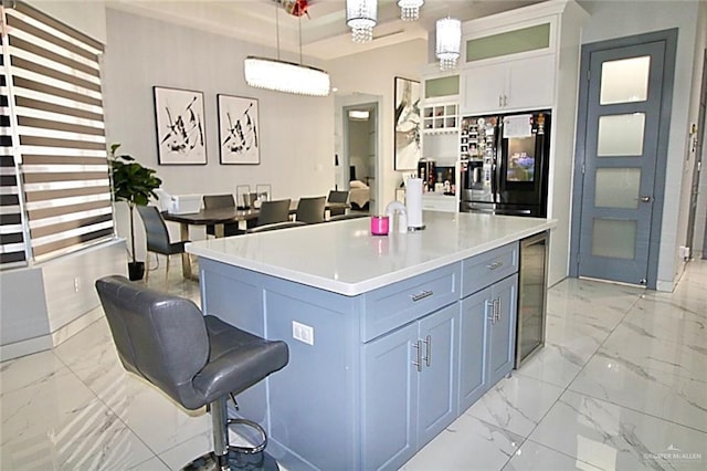2209 David Ave, San Juan, TX 78589 - kitchen featuring hanging light fixtures, a breakfast bar, glass insert cabinets, marble finish floor, and fridge with ice dispenser