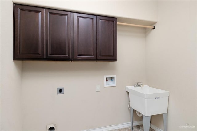 clothes washing area featuring cabinet space, hookup for a washing machine, electric dryer hookup, and baseboards