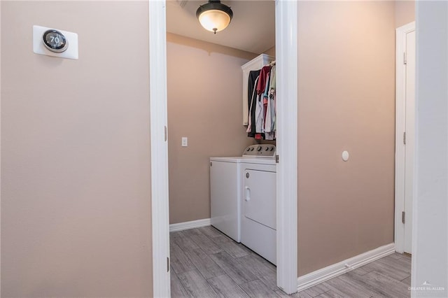 washroom featuring independent washer and dryer and light hardwood / wood-style floors