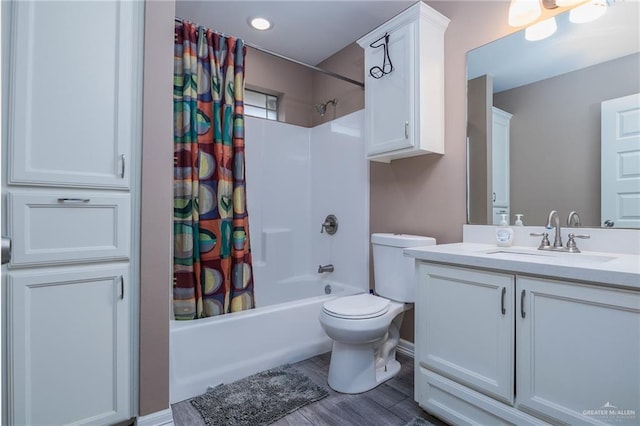 full bathroom featuring vanity, toilet, hardwood / wood-style floors, and shower / bath combo